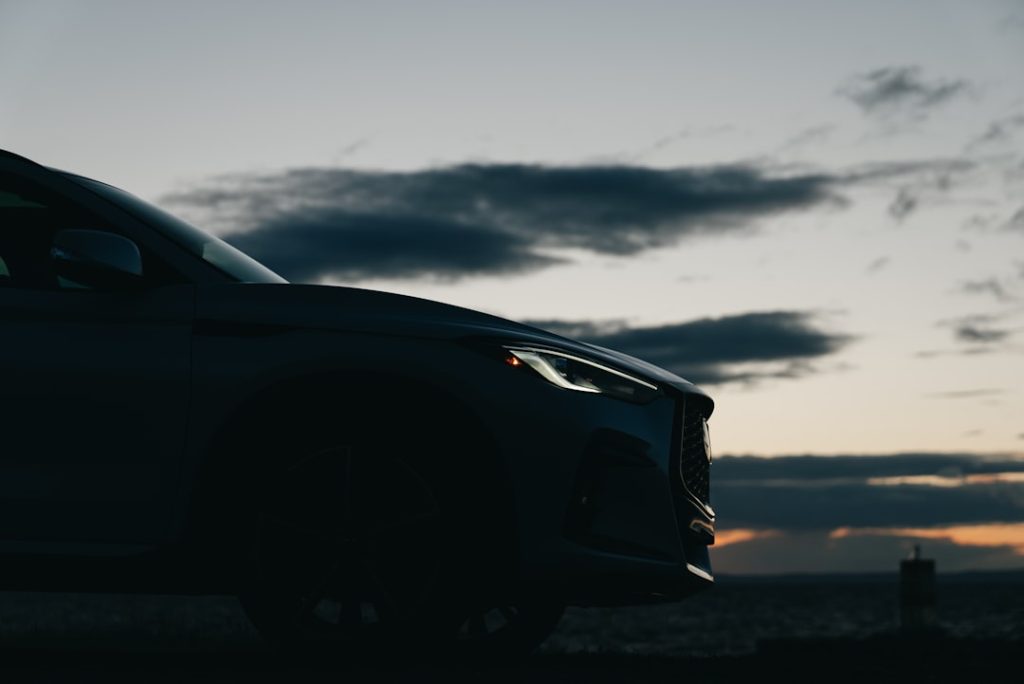 Car parked near lighthouse at dusk