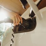 a person pumping gas into a car at a gas station
