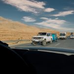 a group of vehicles driving on a highway