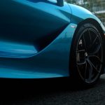a blue sports car parked on the side of the road