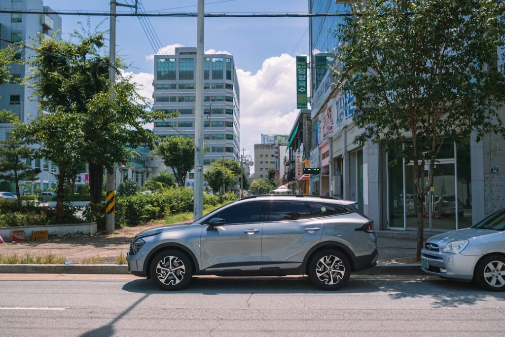 Silver suv parked on a city street