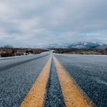 landscape photography of asphalt road under cloudy sky during daytime