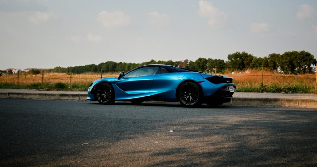 a blue sports car parked on the side of the road