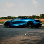 a blue sports car parked on the side of the road