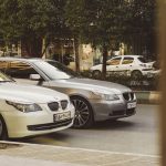 white BMW vehicle on gray top road