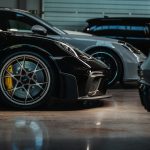 a couple of cars parked next to each other in a garage