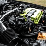 Toyota Desenvolve Esportivo Inedito Com Motor Central E Tracao Integral O Que Sabemos Ate Agora the engine compartment of a car with a yellow engine
